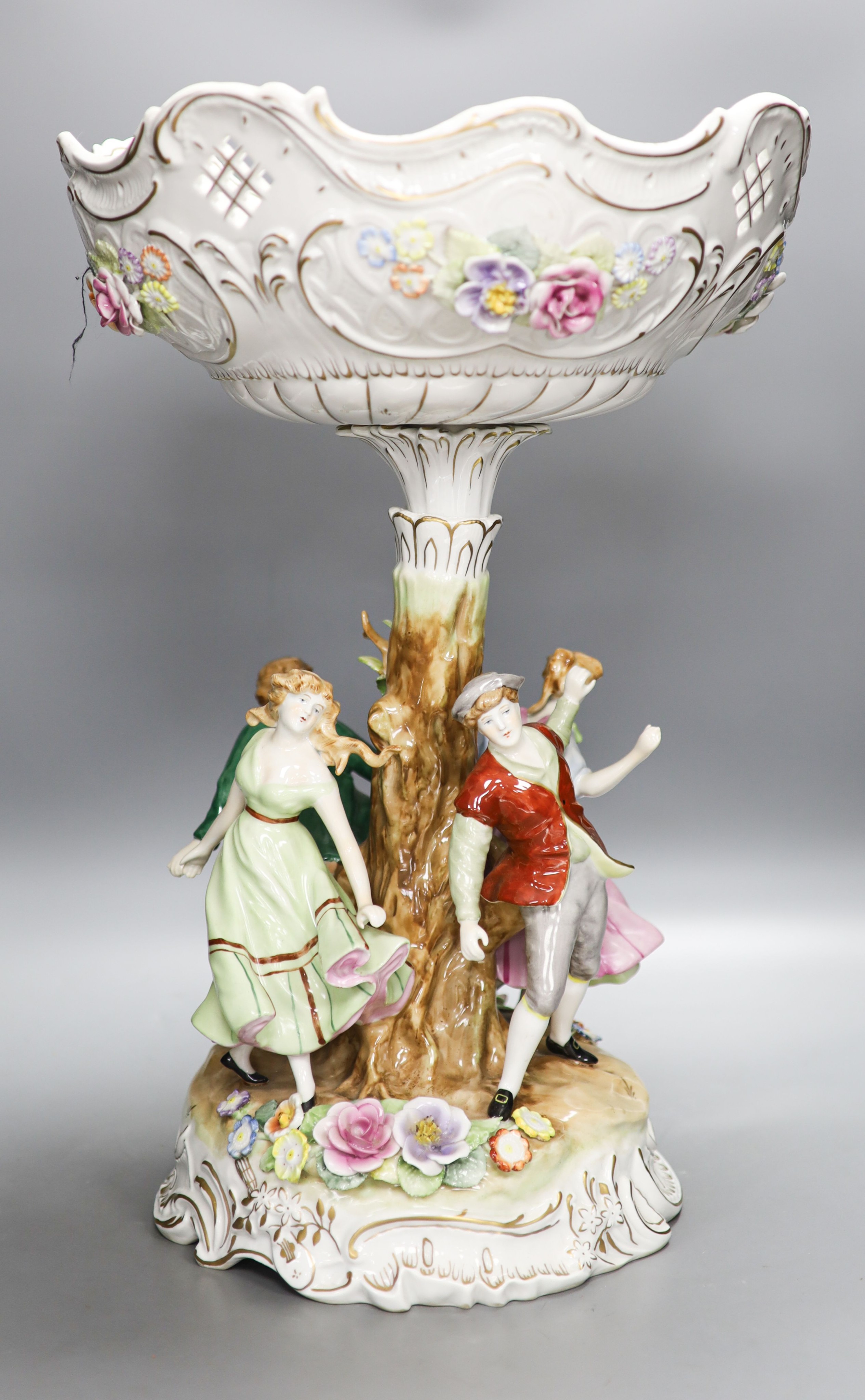 A German porcelain fruit stand, the stem decorated with four dancing figures 51cm